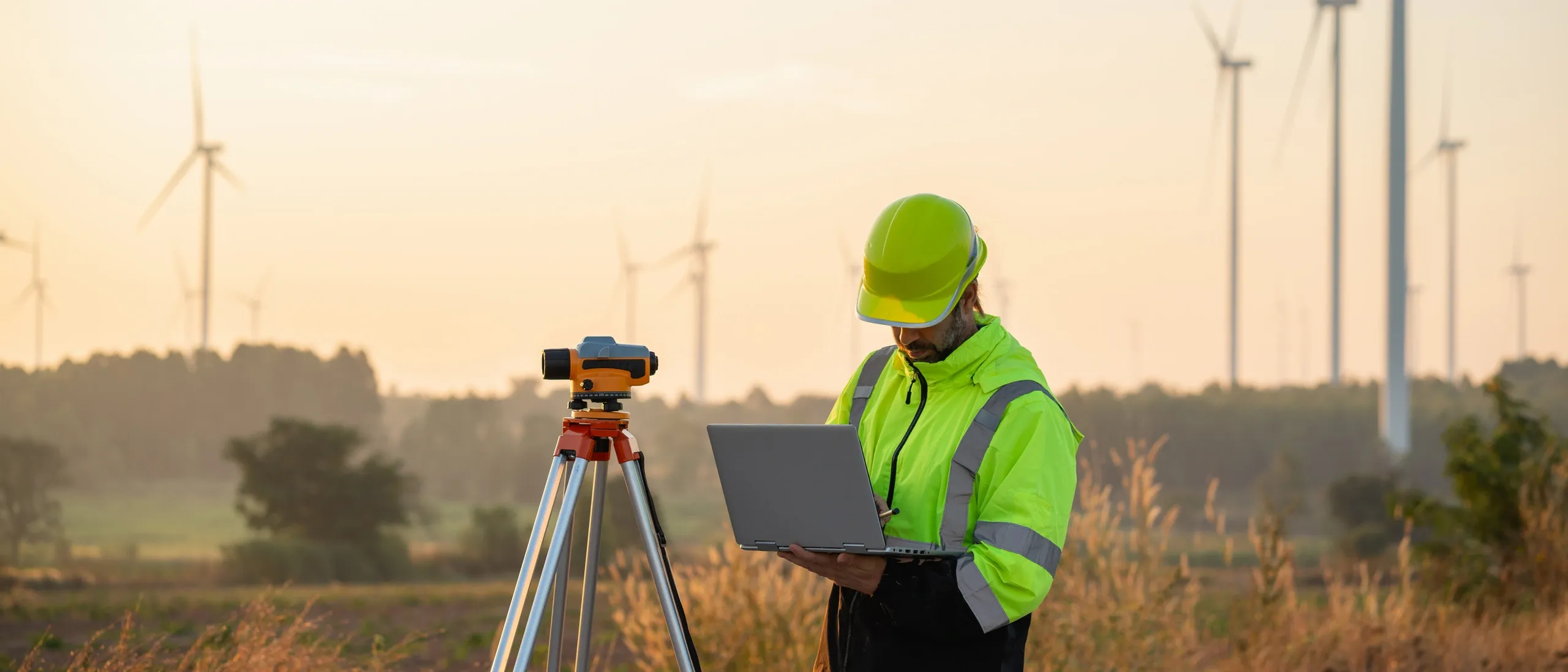 Surveyor with total station equipment in field